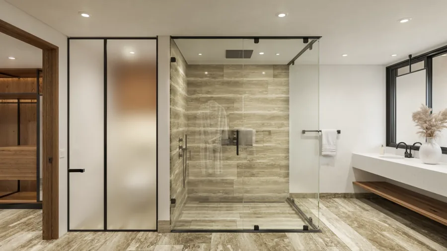 Baño principal propuesto, con superficies pétreas, cancel de vidrio y carpintería